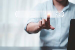 A digital marketing professional using a virtual search bar to perform keyword research for SEO and online marketing.
